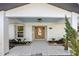 Inviting front entrance with a covered porch and light-colored tile at 625 W Olympia Ave, Punta Gorda, FL 33950