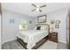 Bright bedroom with a double bed, nightstand, and ceiling fan at 8730 Pickwick Rd, North Port, FL 34287