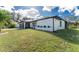 Single-story home, white exterior, and partial view of garage at 1239 Ramsdel St, Port Charlotte, FL 33952