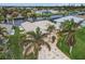 Bird's eye view of a canal-front home with a metal roof and lush landscaping at 15460 Longview Rd, Port Charlotte, FL 33981