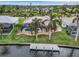 Aerial view of a canal-front property with a private dock and a swimming pool at 15460 Longview Rd, Port Charlotte, FL 33981