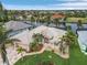 Aerial view showcasing a single-Gathering home's exterior, highlighting its metal roof and canal-side location at 15460 Longview Rd, Port Charlotte, FL 33981