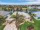 Aerial view of a single-Gathering home on a canal, featuring a metal roof and palm trees at 15460 Longview Rd, Port Charlotte, FL 33981