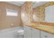 Guest bathroom with tub, toilet, and a vanity with granite countertop at 15460 Longview Rd, Port Charlotte, FL 33981