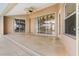 Spacious covered patio with stone flooring, access to pool, and sliding glass doors at 15460 Longview Rd, Port Charlotte, FL 33981