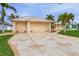 Tan two-story house with a two-car garage and landscaped yard at 15460 Longview Rd, Port Charlotte, FL 33981