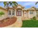 Front entrance with double doors and a curved walkway at 15460 Longview Rd, Port Charlotte, FL 33981