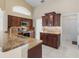 Kitchen with granite countertops, wood cabinets, and breakfast bar at 15460 Longview Rd, Port Charlotte, FL 33981