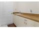 Bright laundry room with countertop sink and ample cabinet storage at 15460 Longview Rd, Port Charlotte, FL 33981