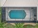 An aerial view of a private, screened-in pool with a unique shape at 15460 Longview Rd, Port Charlotte, FL 33981