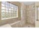 Large walk-in shower with built-in seat and glass block window at 15460 Longview Rd, Port Charlotte, FL 33981