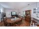 Charming dining room with wooden table and view into kitchen at 1568 Red Oak Ln, Port Charlotte, FL 33948