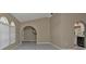 Open living room with tile floors, arched entryways, and kitchen views at 167 Mocha Ct, Punta Gorda, FL 33983