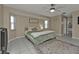 Main bedroom with king bed, ceiling fan, and access to bathroom at 167 Mocha Ct, Punta Gorda, FL 33983