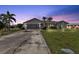 Single-story home with a two-car garage and landscaped lawn at 167 Mocha Ct, Punta Gorda, FL 33983