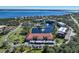 Aerial view of community with lake, pool, and lush landscaping at 23465 Harborview Rd # 1028, Punta Gorda, FL 33980