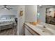 Bathroom with a single sink vanity and view into bedroom at 23465 Harborview Rd # 1028, Punta Gorda, FL 33980