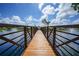 Picturesque wooden footbridge over a lake with fountains at 23465 Harborview Rd # 1028, Punta Gorda, FL 33980