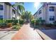 Welcoming condo building entrance with landscaped walkway at 23465 Harborview Rd # 1028, Punta Gorda, FL 33980
