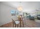 Bright dining area with a small table and chairs near the living room at 23465 Harborview Rd # 1028, Punta Gorda, FL 33980