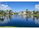 Community with a lake, bridge, and residential buildings at 23465 Harborview Rd # 1028, Punta Gorda, FL 33980