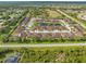 Aerial view of community with pond, pool, and numerous houses at 4410 Turnberry Cir, North Port, FL 34288