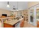 Open kitchen with island, granite countertops, and stainless steel appliances at 4410 Turnberry Cir, North Port, FL 34288
