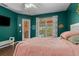 Bedroom with green walls, hardwood floors, and access to a patio at 4410 Turnberry Cir, North Port, FL 34288