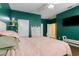 Bedroom with green walls, hardwood floors, and a TV at 4410 Turnberry Cir, North Port, FL 34288