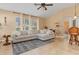 Bright and airy living area with an L-shaped sofa and large windows at 4410 Turnberry Cir, North Port, FL 34288