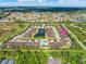 Aerial view of community with pond and pool, highlighting a specific house at 4410 Turnberry Cir, North Port, FL 34288