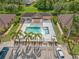 Community pool with surrounding patio and palm trees at 4410 Turnberry Cir, North Port, FL 34288