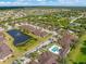 Aerial view of community with pond, pool, and various houses at 4410 Turnberry Cir, North Port, FL 34288