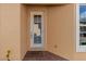 Exterior view of home featuring a side entrance and brick walkway at 4410 Turnberry Cir, North Port, FL 34288