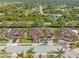 Aerial view of a community with houses, palm trees, and a pond at 4410 Turnberry Cir, North Port, FL 34288