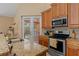 Kitchen features granite countertops, stainless steel appliances, and French doors to the pool area at 4410 Turnberry Cir, North Port, FL 34288