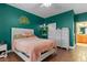 Bedroom with green walls, hardwood floors, and a white dresser at 4410 Turnberry Cir, North Port, FL 34288