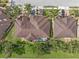 Aerial view of two houses with pools and lush landscaping at 4410 Turnberry Cir, North Port, FL 34288