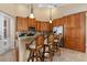 Kitchen with wood cabinets, breakfast bar, and stainless steel appliances at 4410 Turnberry Cir, North Port, FL 34288