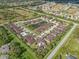Aerial view of community with pond, pool, and many houses at 4410 Turnberry Cir, North Port, FL 34288