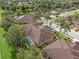 Aerial view of houses, palm trees, and a pool in a community at 4410 Turnberry Cir, North Port, FL 34288