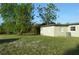 Spacious backyard with grassy area and mature trees at 1311 Lindsay Ave, Punta Gorda, FL 33982