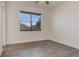 Bright bedroom with wood-look floors and a window with blinds at 1488 Nackman Rd, North Port, FL 34288