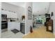 Kitchen with white cabinets, stainless steel appliances and view to living room at 19310 Water Oak Dr # 203, Port Charlotte, FL 33948