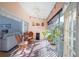 Bright screened porch offers outdoor living space with seating at 19310 Water Oak Dr # 203, Port Charlotte, FL 33948
