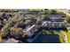 Aerial view of a community with lush landscaping, a pond, and numerous residential buildings at 19310 Water Oak Dr # 203, Port Charlotte, FL 33948