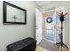 Inviting entryway with bench, mirror, and coat rack at 19310 Water Oak Dr # 203, Port Charlotte, FL 33948