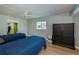 Two twin beds, ceiling fan, and dresser at 22532 Ashton Ave, Punta Gorda, FL 33980