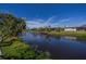 Tranquil canal view with lush vegetation and neighboring houses at 22532 Ashton Ave, Punta Gorda, FL 33980