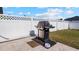 Gas grill on patio next to white fence at 2705 Lamkin Rd, North Port, FL 34288